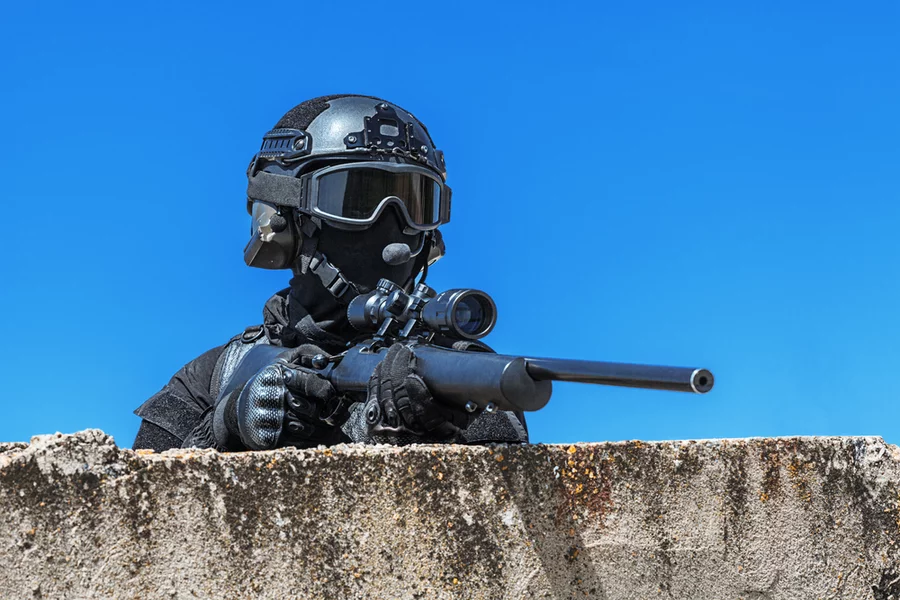 SWAT police officer in strategic position.